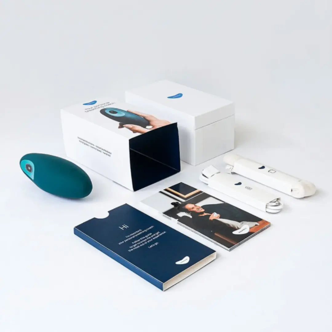 Moonbird breathing coach packaging with product accessories and instruction materials.