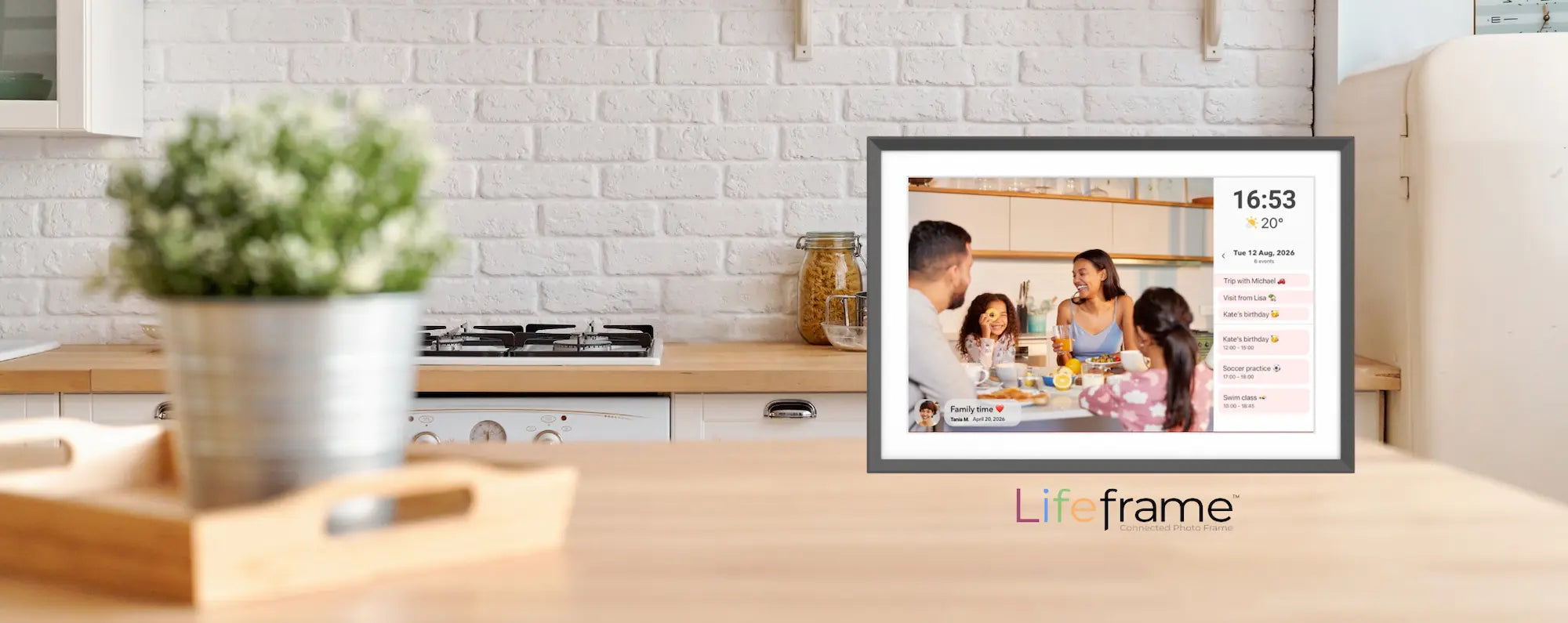 Lifeframe digital family calendar displayed on a kitchen bench showing family photos, weather, time and daily events.