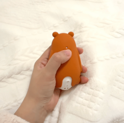 Child holding Moonbuddy breathing aid in bed for screen-free bedtime calming and relaxation.