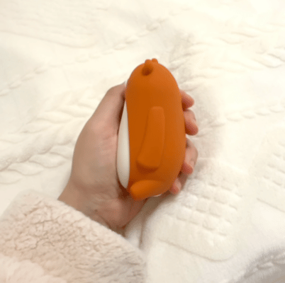 Moonbuddy breathing device gently expanding in a child’s hand to support calm breathing before sleep.