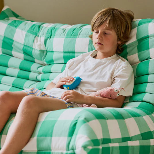 Moonbuddy breathing coach helping a child practise calm breathing on a couch.