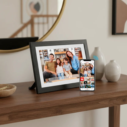 Lifeframe Frameo digital photo frame displaying an Australian family photo with the Frameo app on a smartphone beside it.