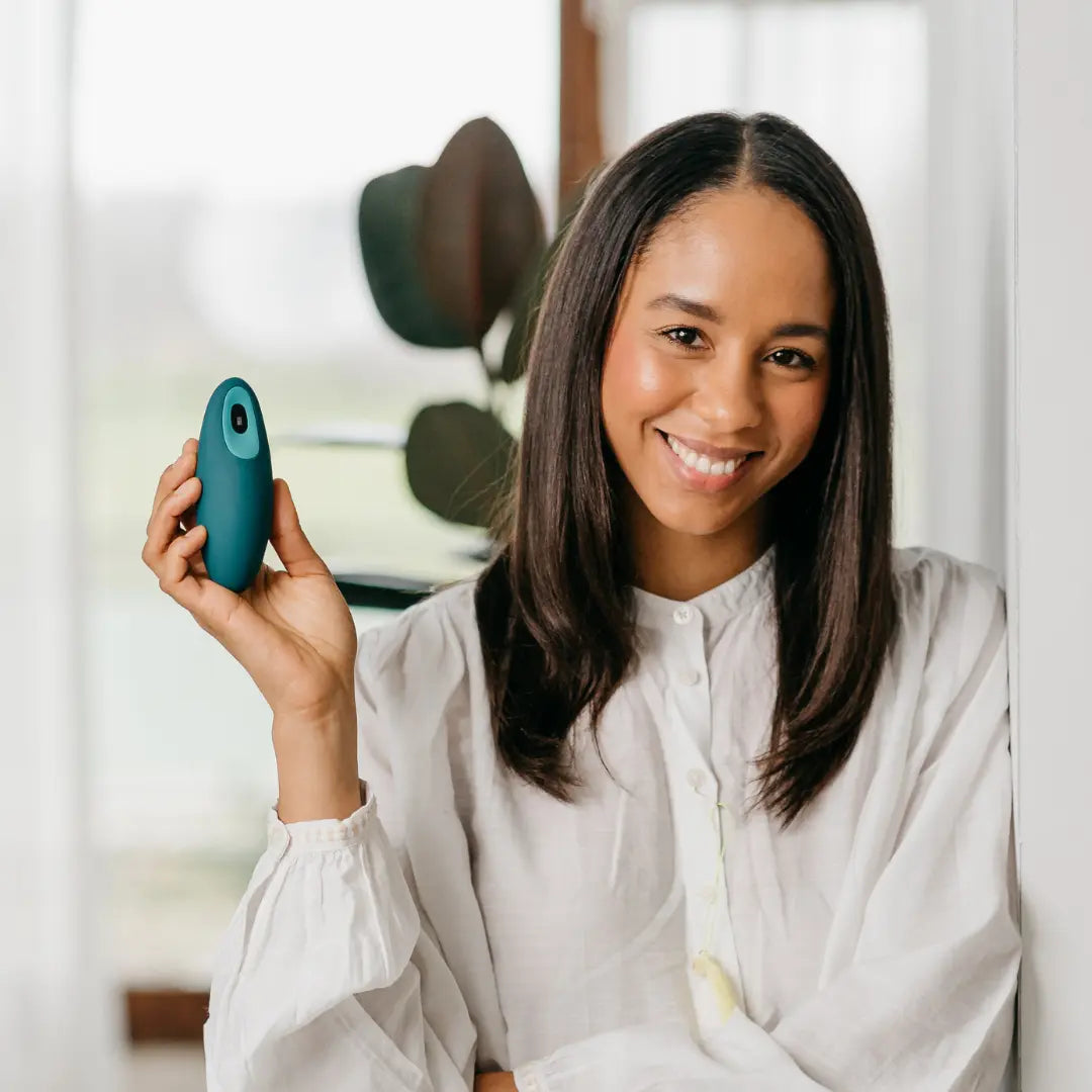 Teal Moonbird handheld breathing coach shown in a relaxed home setting.