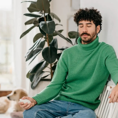 Man using Moonbird breathing coach during a calm seated breathing session at home.