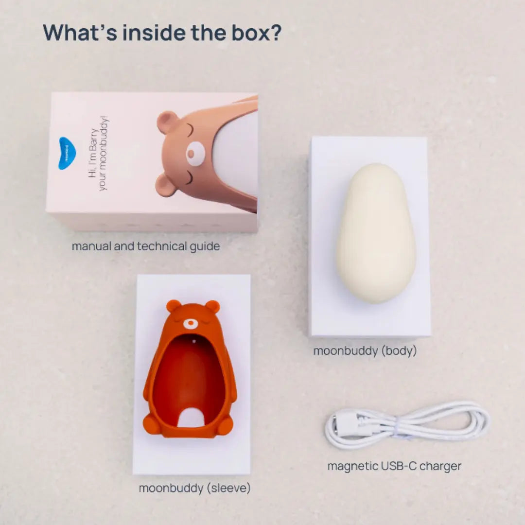 Moonbuddy box contents with device body, soft sleeve, manual and magnetic USB-C charger.