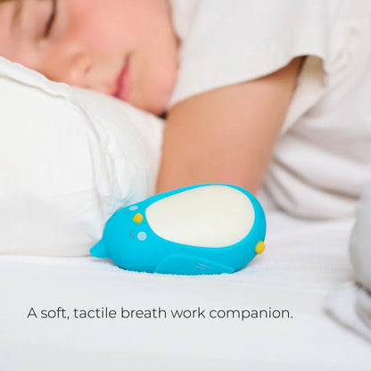 Moonbuddy breathing coach for children resting beside a sleeping child at bedtime.